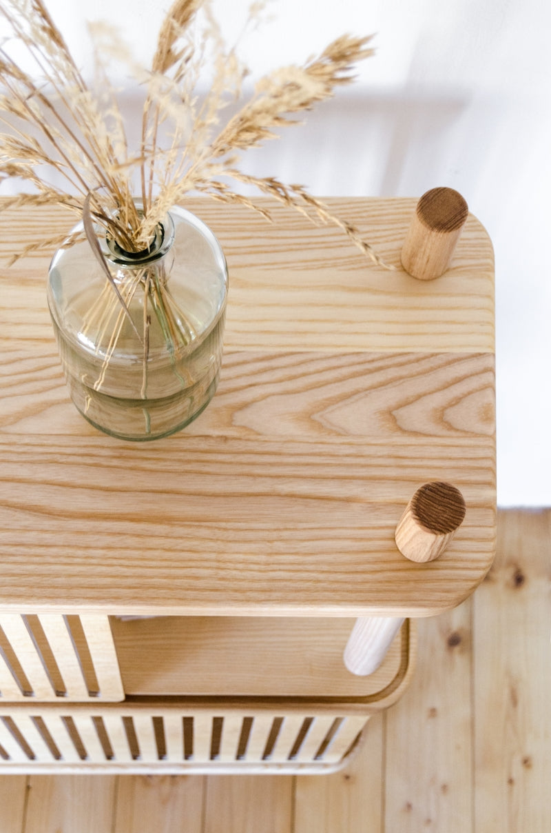 A wooden table topped with a vase filled with flowers