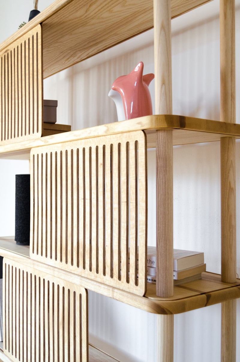 A wooden shelf with a vase on top of it