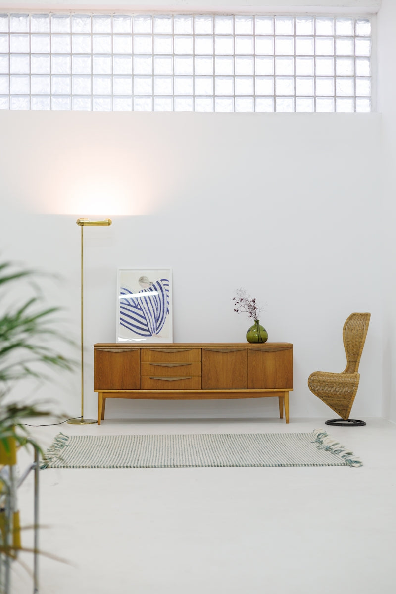 A living room with a couch, chair, table and lamp