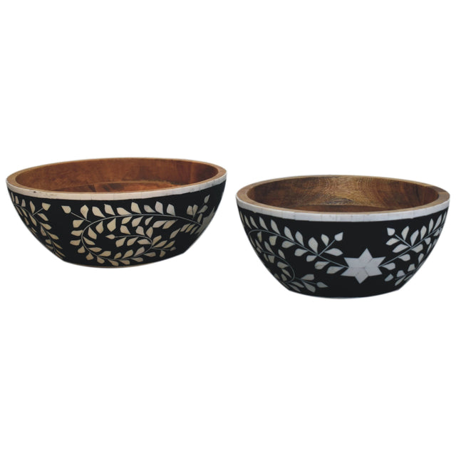Two black mango wood bowls with a white floral resin inlay pattern.