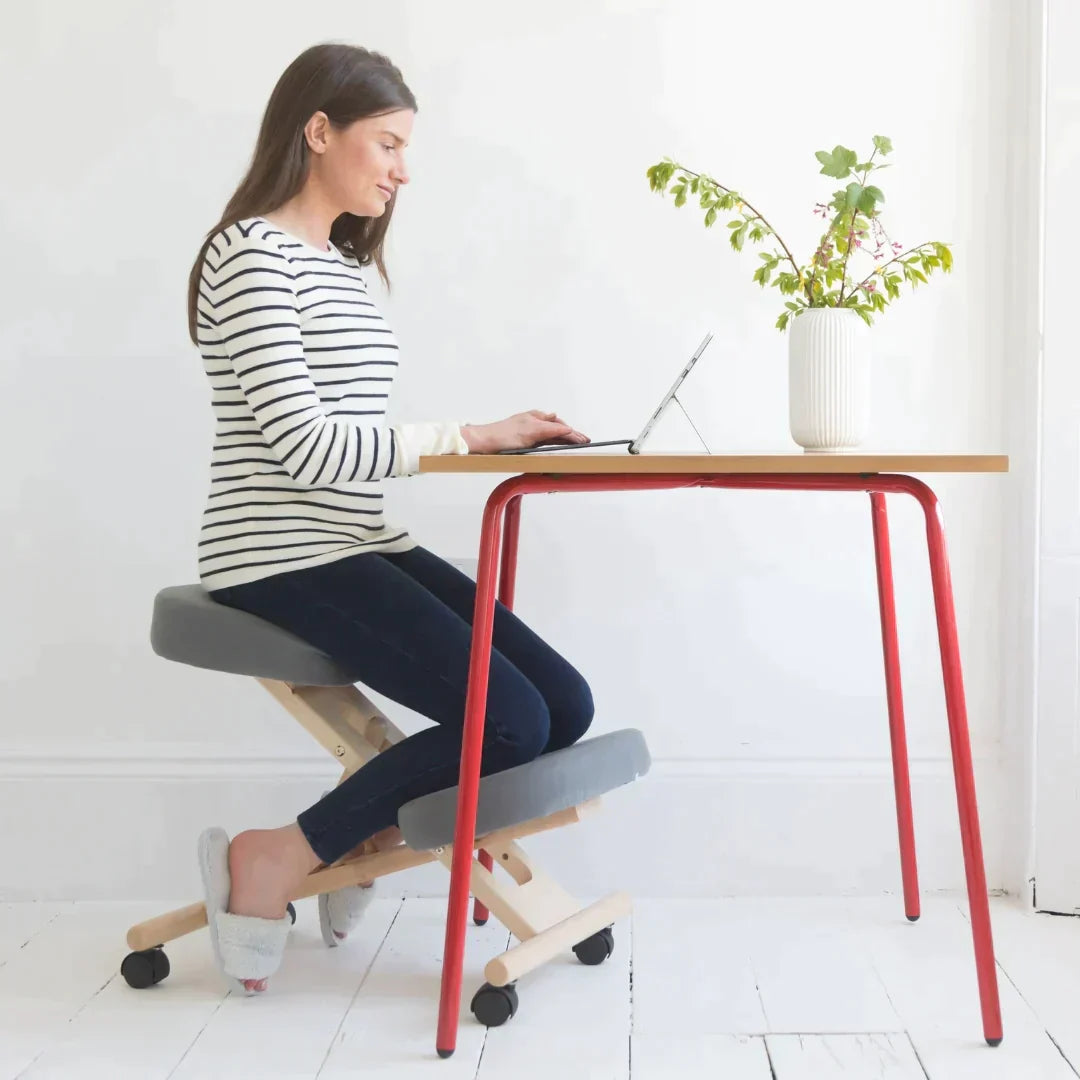 Kneeling chair with gray cushions.