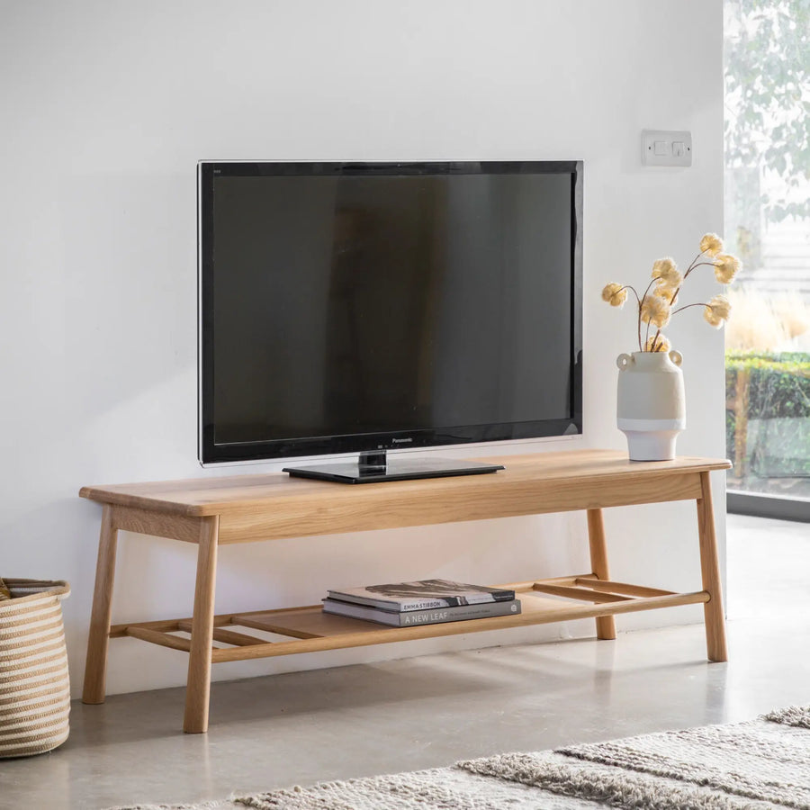 Wooden TV stand with shelf.