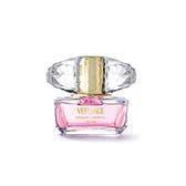 Versace Bright Crystal Eau de Toilette perfume bottle with pink liquid, a faceted clear cap, and a gold collar, centered on a white background.