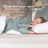 Person lying on a bed with a contoured pillow, text about support and product details.