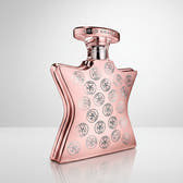 Pink and silver perfume bottle with decorative elements on a white background