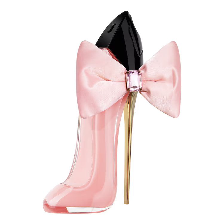 Pink high-heeled shoe with a large bow on a white background