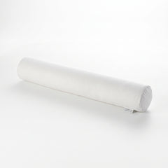 A white cylindrical cervical neck bolster pillow with a small fabric tag near one end, photographed on a seamless white studio background.