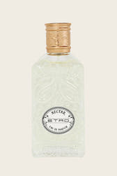 A clear glass perfume bottle with embossed floral detailing, featuring a gold-toned cap and a circular black-and-white label that reads 'NECTAR ETRO EAU DE PARFUM'.