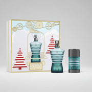 Jean Paul Gaultier Le Male fragrance gift set featuring a striped blue-green perfume bottle, a matching deodorant stick, and a decorative illustrated box with gears, mountains, and red-and-white Christmas trees.