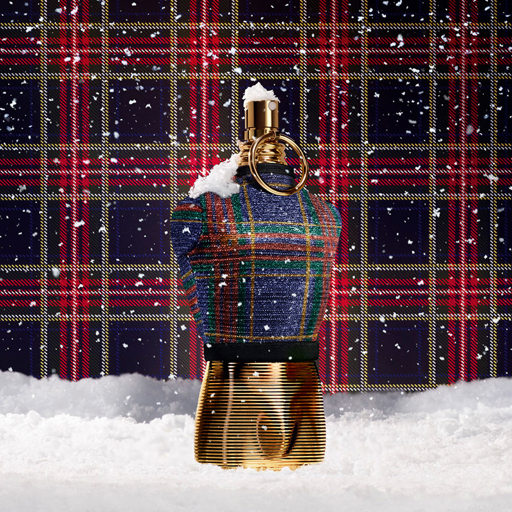 Decorative bell with tartan pattern and gold base against a plaid background