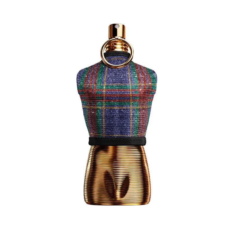 A perfume bottle shaped like a miniature mannequin torso, featuring a blue, green, and red plaid tweed upper section and a metallic gold ribbed lower section with a gold ring neck detail, set against a plain white background.