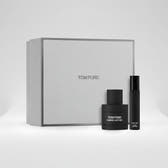 Tom Ford Ombre Leather fragrance set featuring a large textured light gray gift box, a black perfume bottle, and a slim black travel atomizer spray bottle, with a '2 pack' badge in the top right corner.