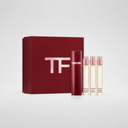 Tom Ford fragrance gift set featuring a large dark red box with a metallic silver TF logo, a matching dark red cylindrical bottle, and three clear sample vials with pink caps, all on a white background.