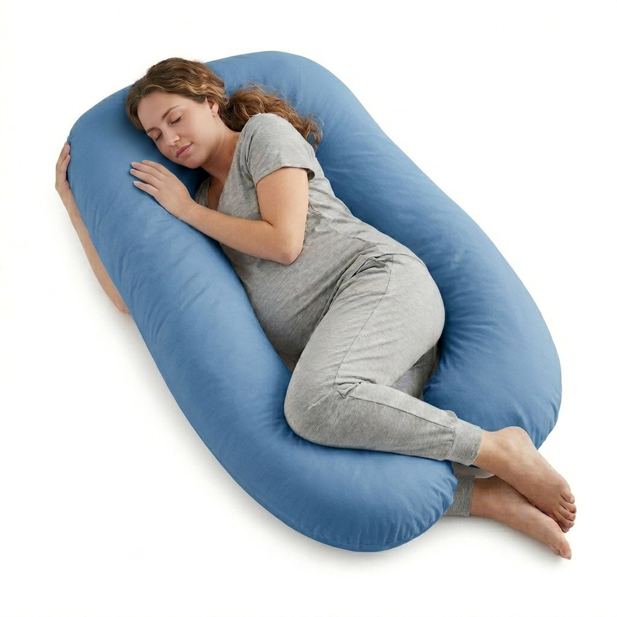 Woman lying on a large blue U-shaped pillow on a white background