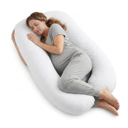 Woman lying on a large U-shaped body pillow on a white background
