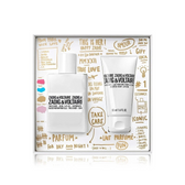 Zadig & Voltairi gift set containing a white perfume bottle and a white body wash tube, presented in a white box decorated with gold doodles and text.