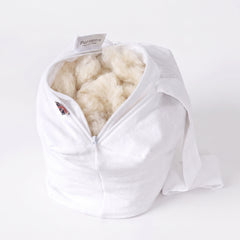British Wool Knee Pillow showing natural fluffy wool filling inside for adjustable side sleeper support.