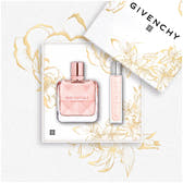 Givenchy Irresistible fragrance set featuring a pink perfume bottle and a matching travel spray tube, presented on a white floral background with the brand's packaging.