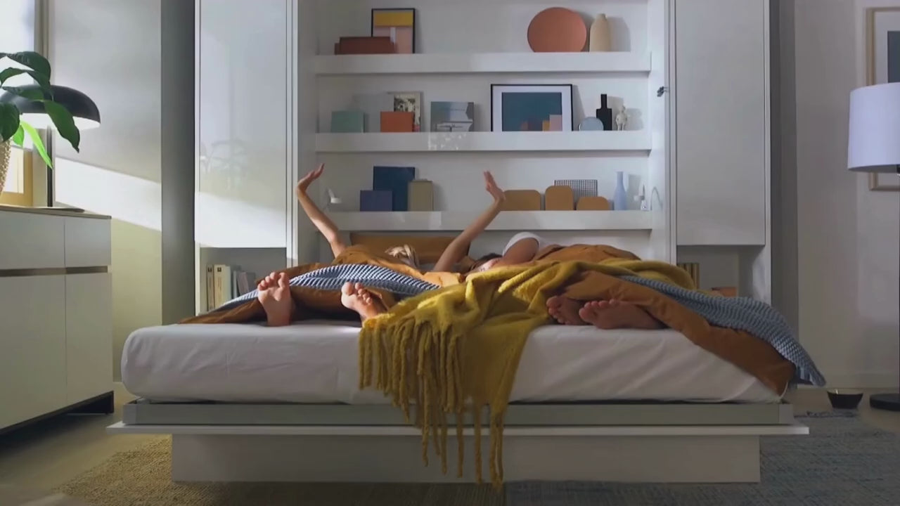 Load video: Couple effortlessly pulling down a premium space-saving horizontal wall bed to instantly transform their living room into a guest bedroom.
